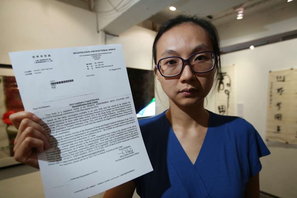 Clara Cheung, chairwoman of STRA, holds a letter sent from the Registration and Electoral Office saying the group has been disqualified from voting. Photo: Edward Wong