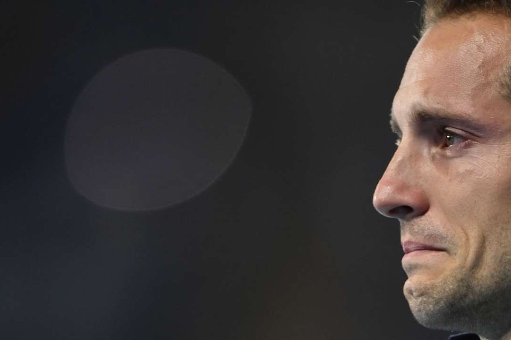 Silver medallist Renaud Lavillenie from France cries during the medal ceremony for the men's pole vault at the Rio 2016 Olympic Games. Photo: AFP