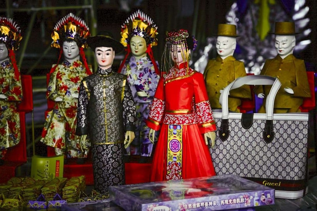 Dolls represent the happy couple in a Chinese-style “ghost wedding”.