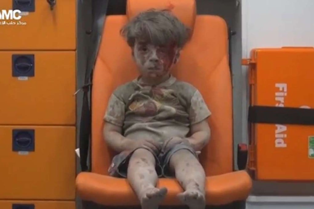 A boy sits in an ambulance after an air strike. Photo: Reuters