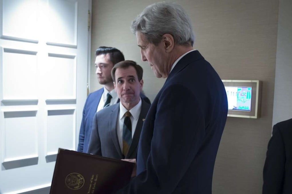 US Secretary of State John Kerry, speaks to senior adviser John Kirby before a news conference in Vienna. Photo: AP