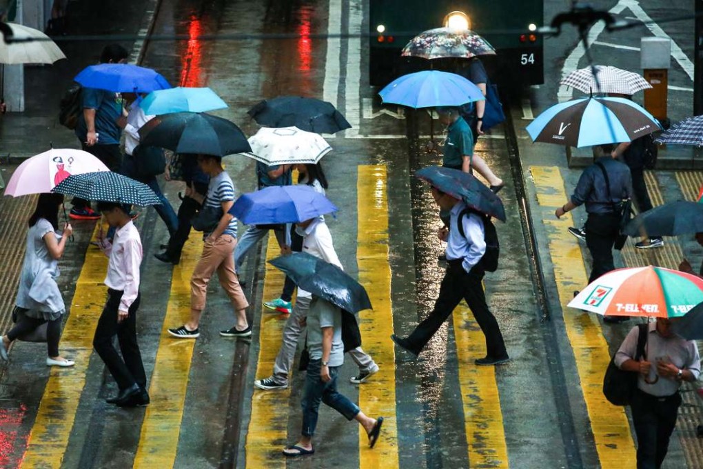 The umbrellas are out in rainy weather. For the sake of the environment, just shake off your wet umbrella before entering a building, rather than take a plastic bag for it. Photo: Nora Tam