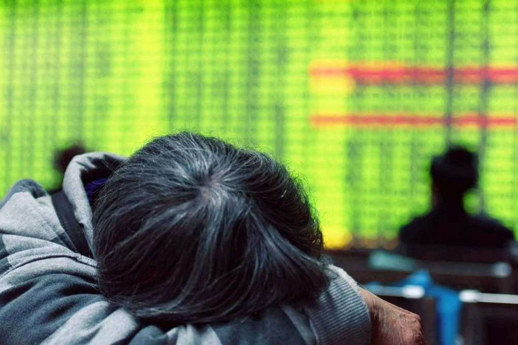 A weary investor after the Shanghai stock index tumbled 5 per cent on January 11. Opposite to global norms, green colour in China’s equity market indicates declines. Photo: AFP