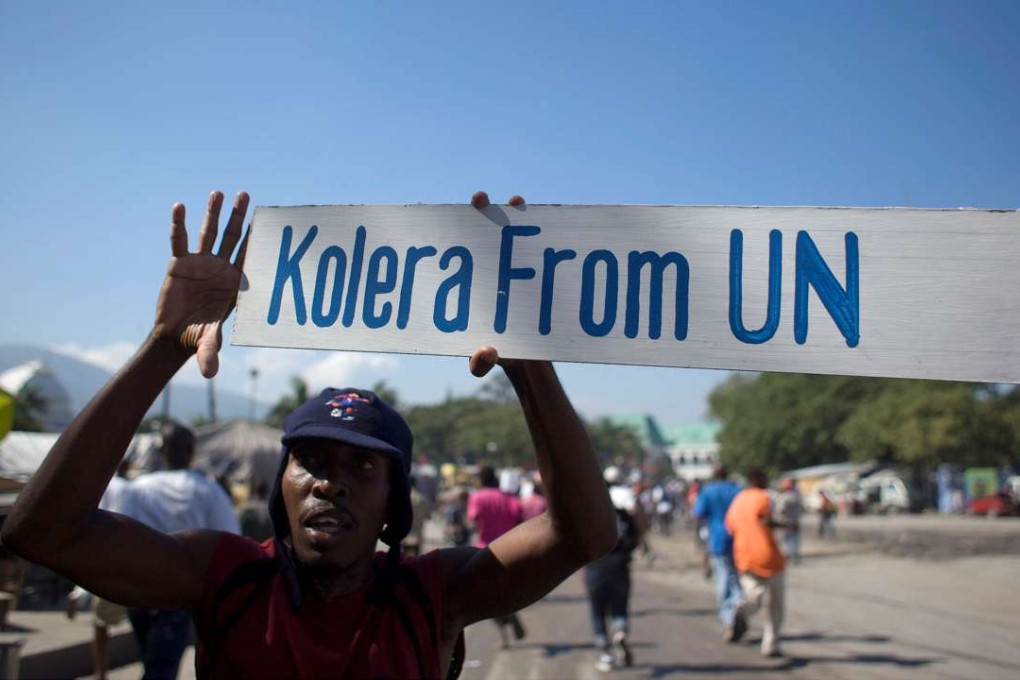 A protester holds up a sign during a demonstration against the UN mission in downtown Port-au-Prince in 2010. Photo: Reuters
