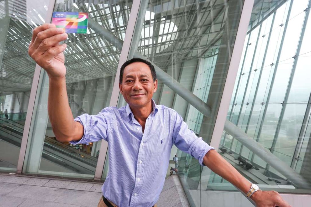 Paul Chan proudly displays the Octopus card he introduced for the MTR. Photo: Jonathan Wong