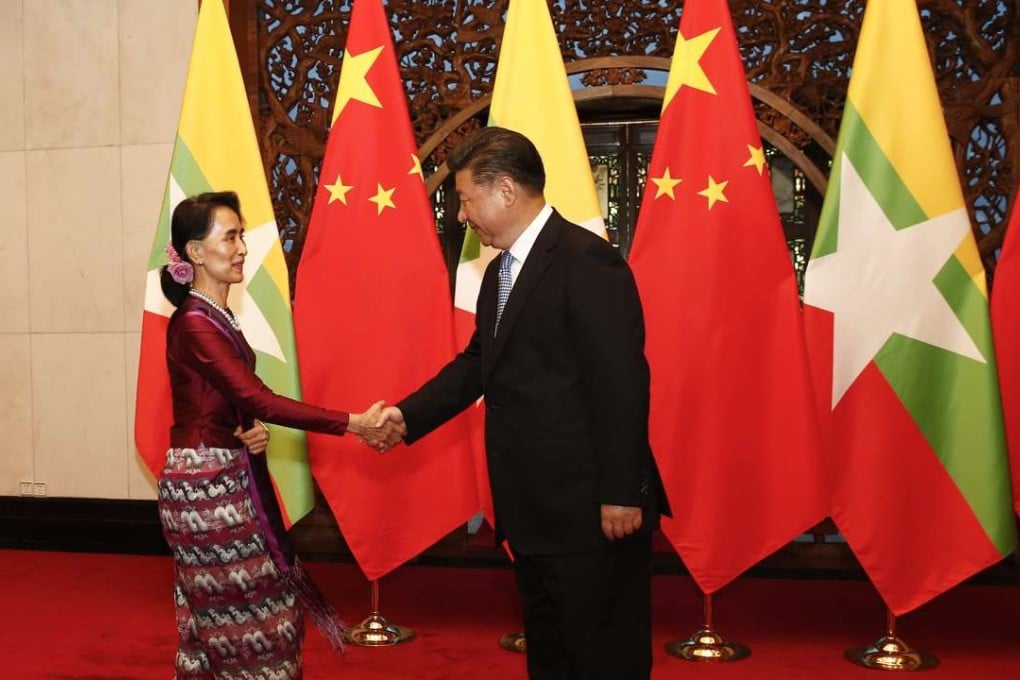 Myanmar State Counsellor Aung San Suu Kyi greets Chinese President Xi Jinping at the Diaoyutai State Guesthouse in Beijing. Photo: EPA