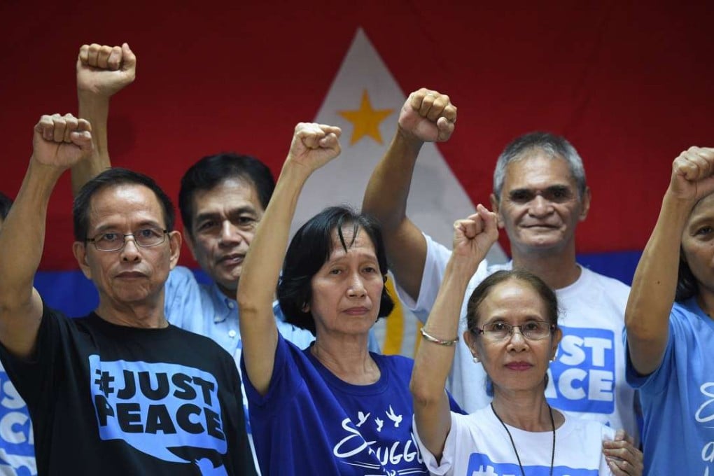 Communist rebel leader Benito Tiamzon (left) his wife, Wilma (in blue) were freed from detention at the police headquarters, ahead of the Oslo peace talks between the government and communist rebels. Photo: AFP