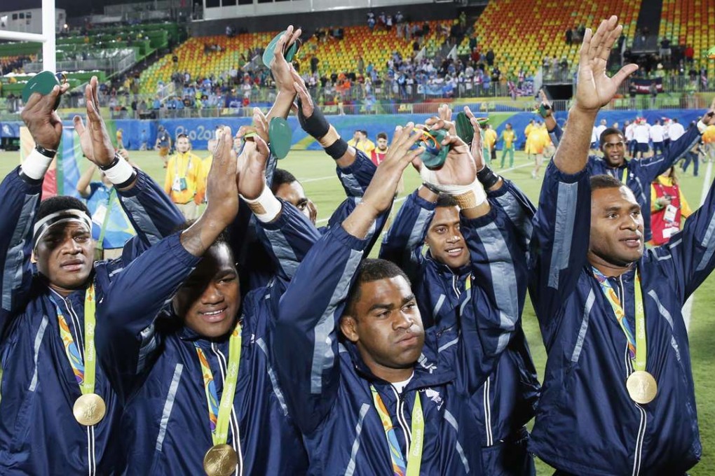 Fiji’s men’s rugby sevens team acknowledge the crowd after beating Britain 43-7 to claim the first ever sevens gold. Photo: Kyodo