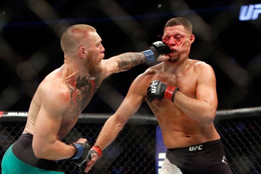 Conor McGregor hits Nate Diaz with a left during their welterweight rematch at the UFC 202 in Las Vegas. Photo: AFP