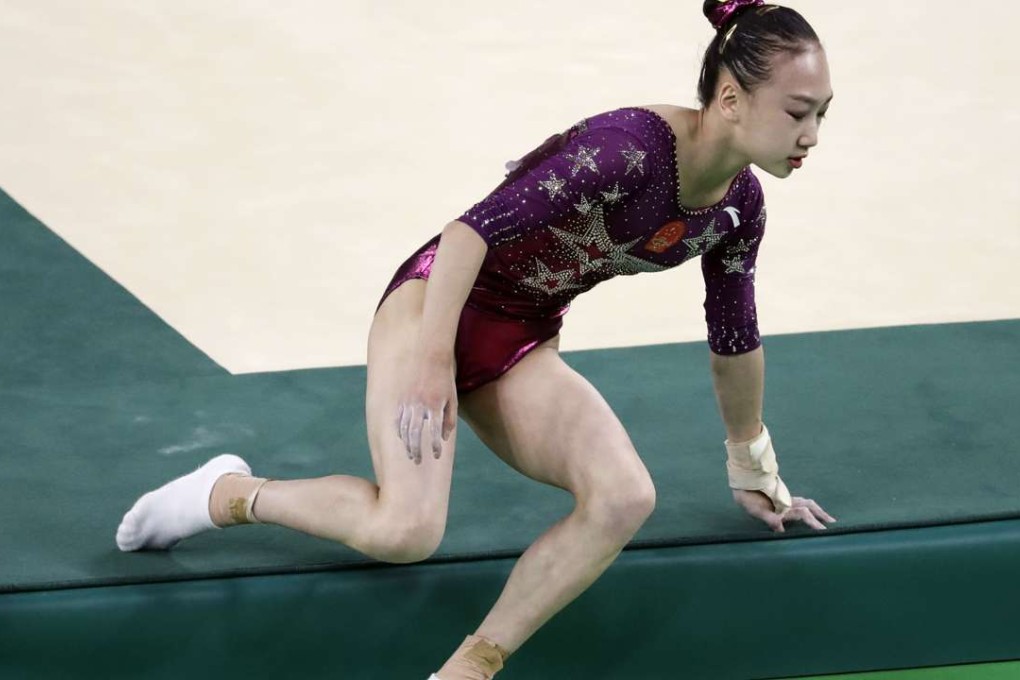 China's Mao Yi falls from the mat as she performs her floor routine during the artistic gymnastics women's team final. Photo: AP