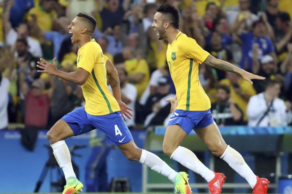 Brazil’s Marquinhos and Felipe Anderson celebrate after sealing the gold medal. Photo: Reuters