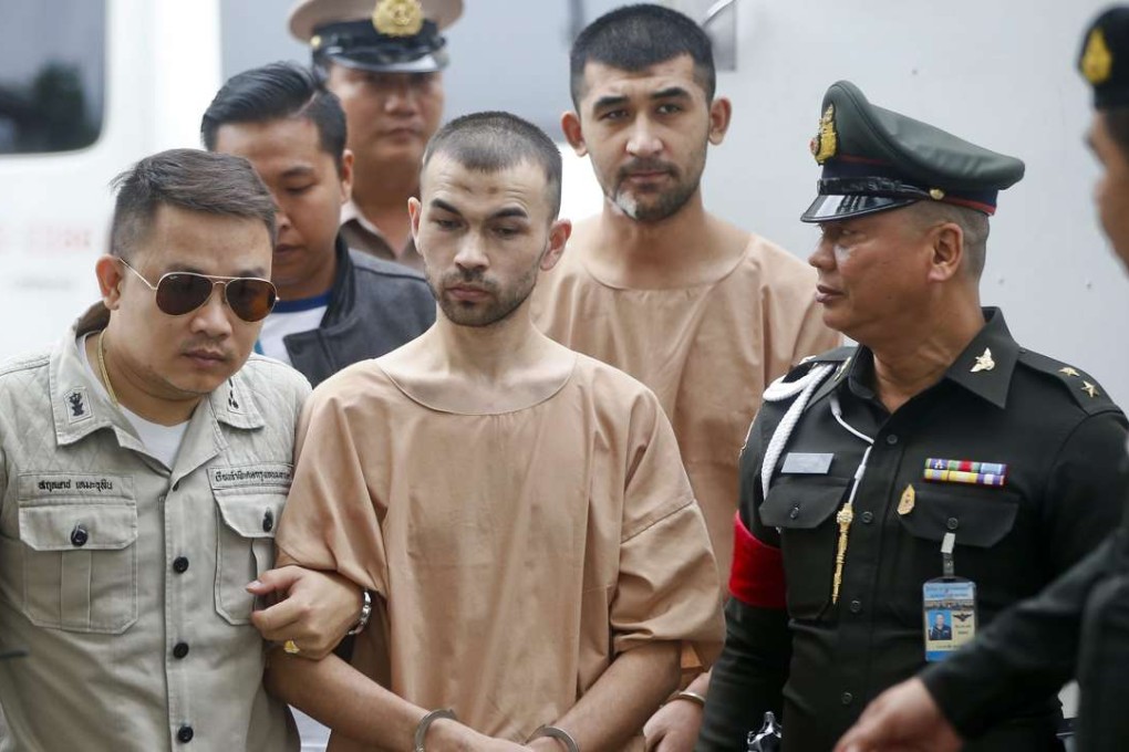 Erawan Shrine's bombing main suspect, identified by Thai police as Adem Karadag front), and Yusufu Mieraili (back) are escorted by officers and prison personnel to the Military Court, in Bangkok, Thailand, February 2016. Photo: EPA