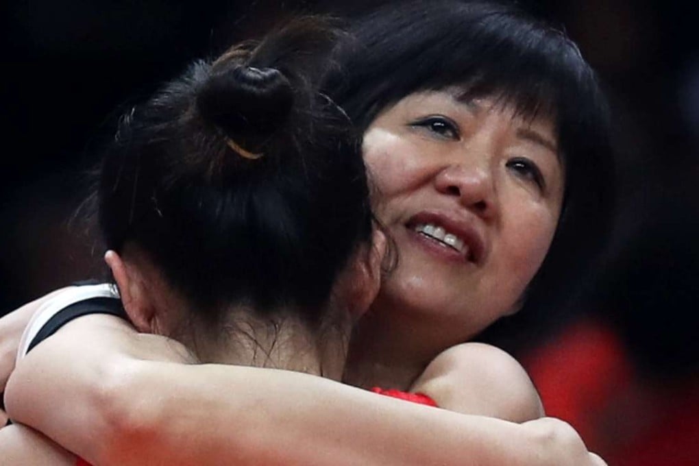 Coach Lang Ping hugs Ding Xia after China beat Serbia in the gold medal match. Photo: Reuters