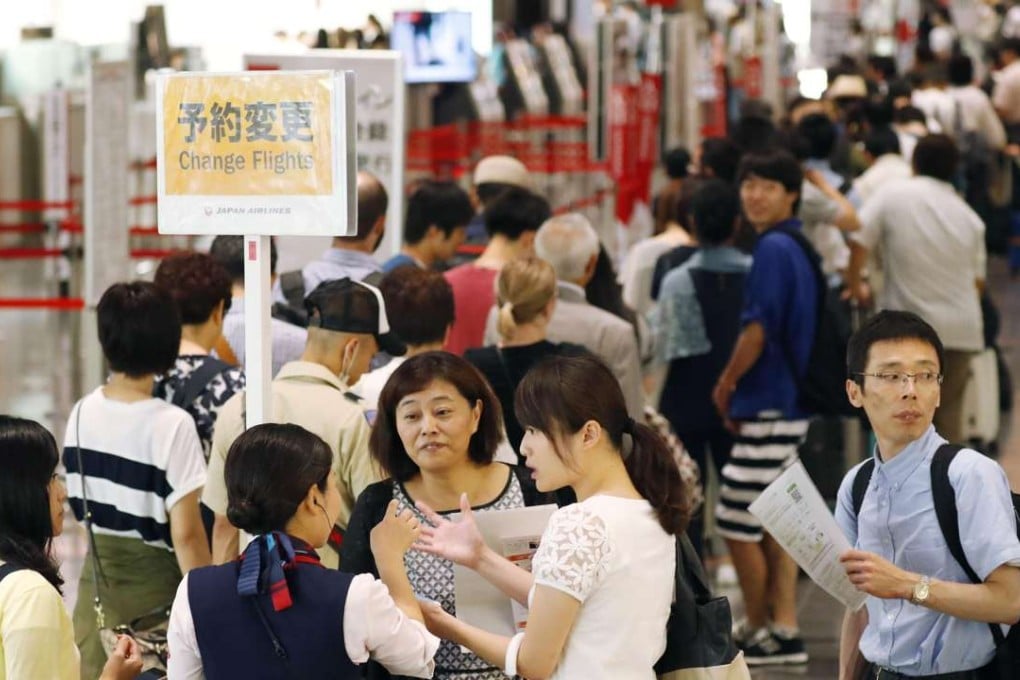 Passengers crowd Tokyo's Haneda airport as hundreds of flights are cancelled due to torrential rain and strong winds brought by Typhoon Mindulle. Photo: Kyodo