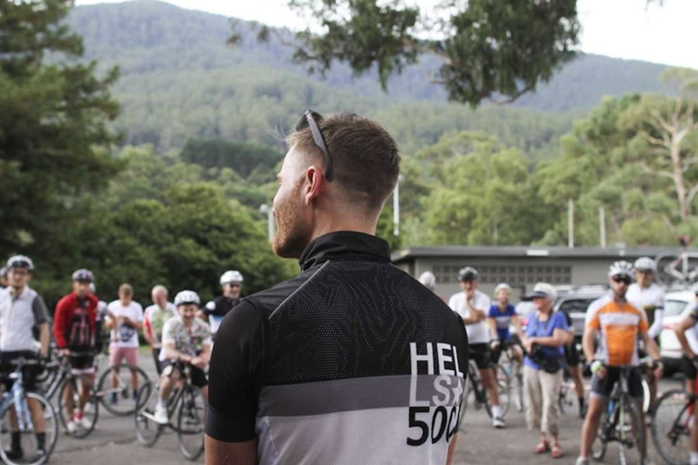 Andy van Bergen (foreground) attends the largest attempt to date when 25 people ‘Everested’ Mount Donna Buang in Australia. Twenty-two were women. More than 300 riders came out to cheer them on.