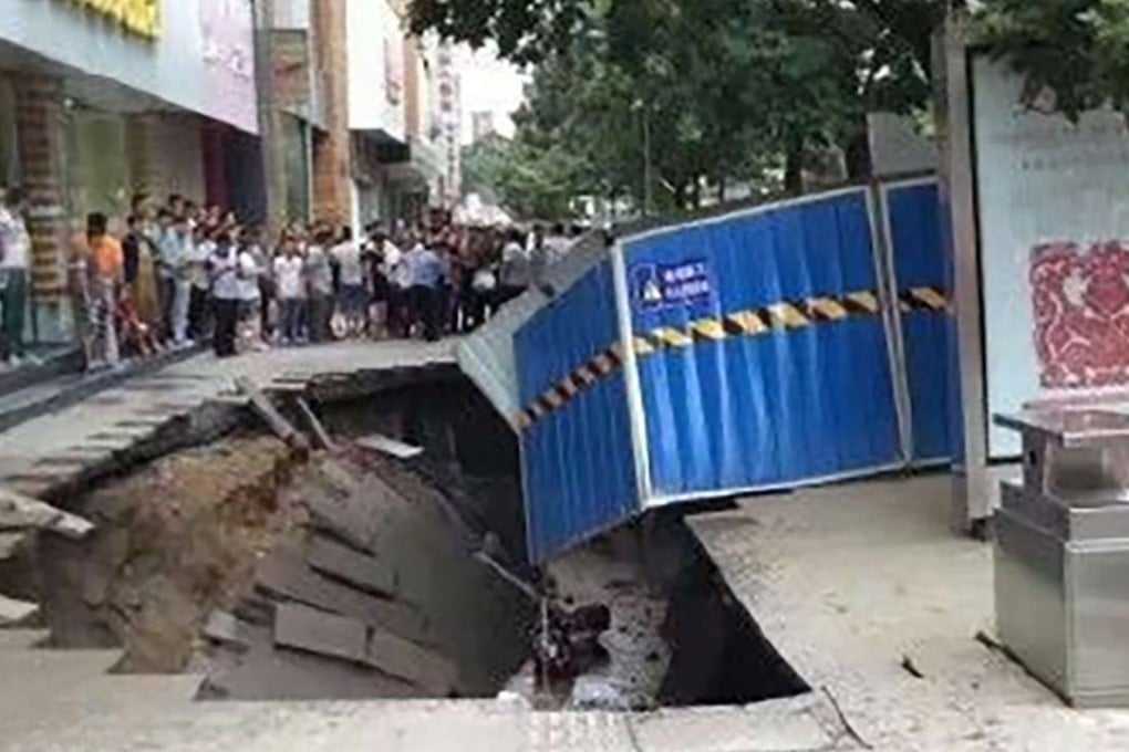 The walkway caved in suddenly in a busy shopping district in Lanzhou, Gansu province. Photo: SCMP Pictures