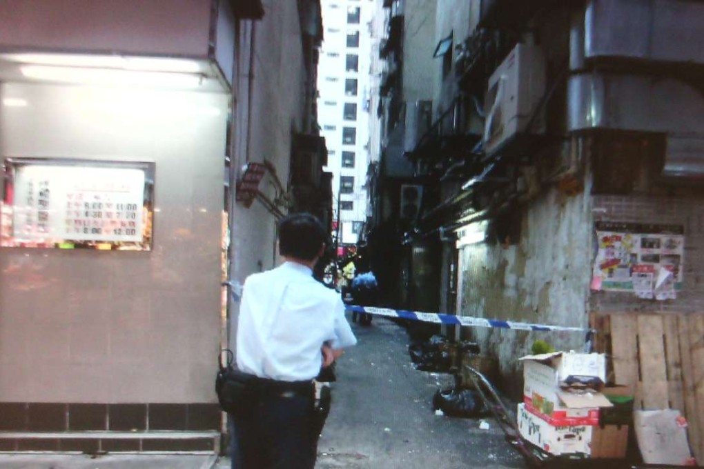 The boy was found by neighbours lying unconscious in a back alley of Man Shing Building shortly before 5pm on Tuesday. Photo: SCMP Pictures