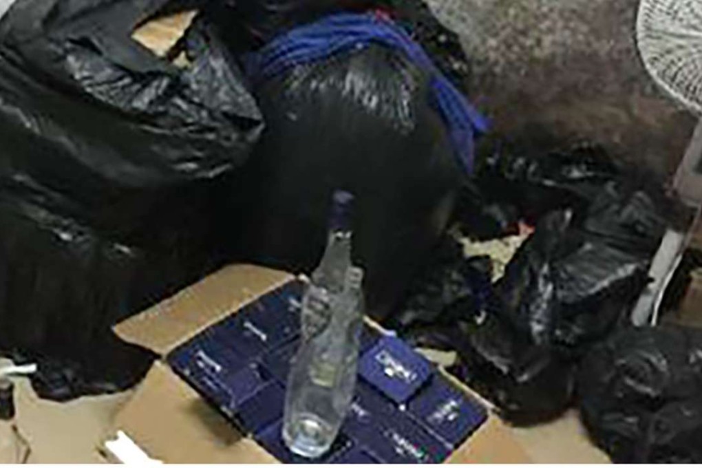 Guanzhou police arrested three men for selling fake alcohol. Photo: SCMP Pictures