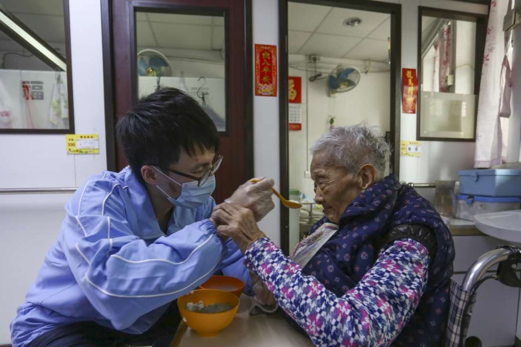 Personal care worker assisting an elderly resident to eat. Photo: Jonathan Wong