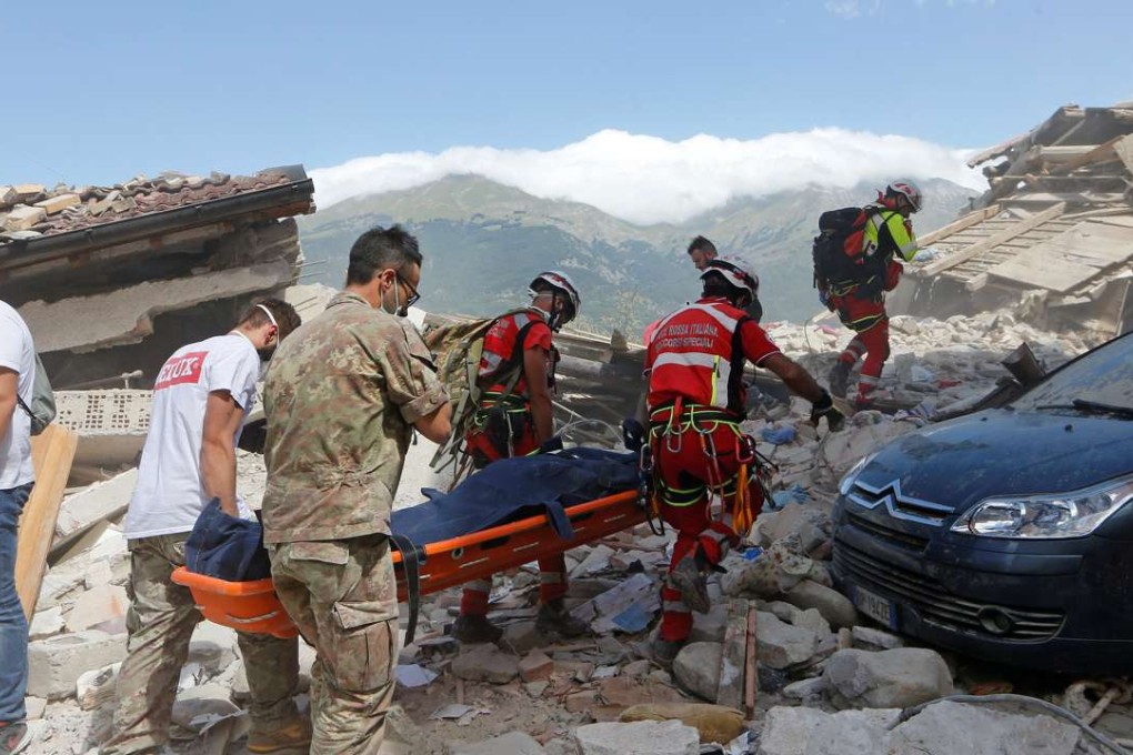 A body is carried away by rescuers following an earthquake in Amatrice, central Italy. Photo: Reuters