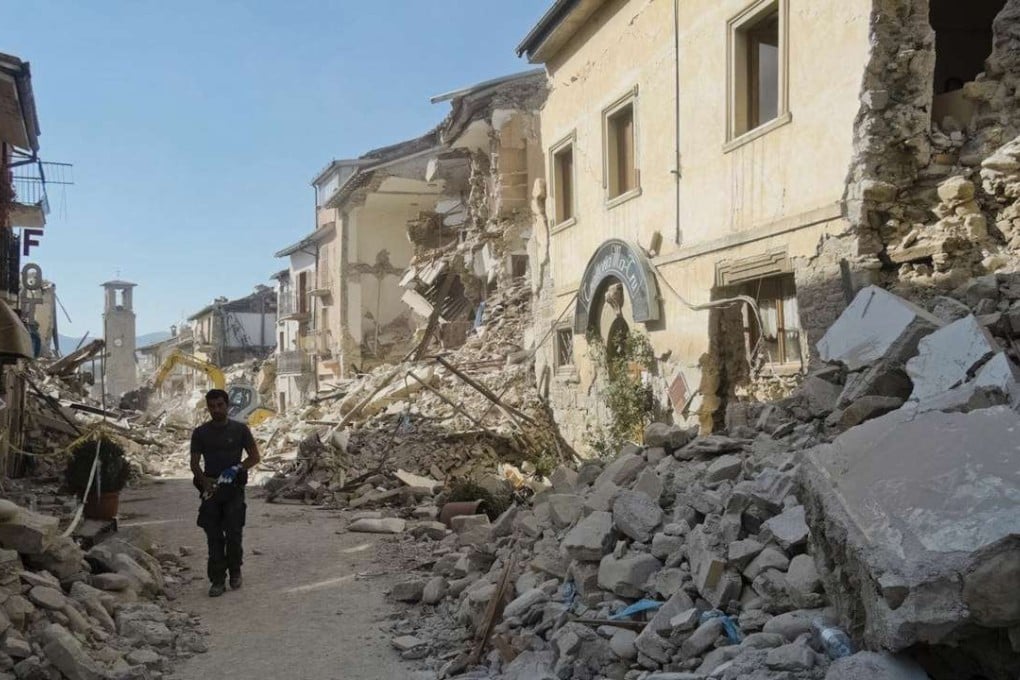 A man walks in a street in Amatrice, central Italy, where a 6.1 earthquake struck on Wednesday. Photo: AP
