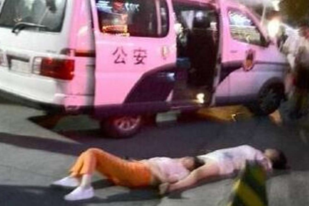 The two women lie unconscious on the street after their marathon quarrel in Ankang, Shaanxi. Photo: SCMP Pictures