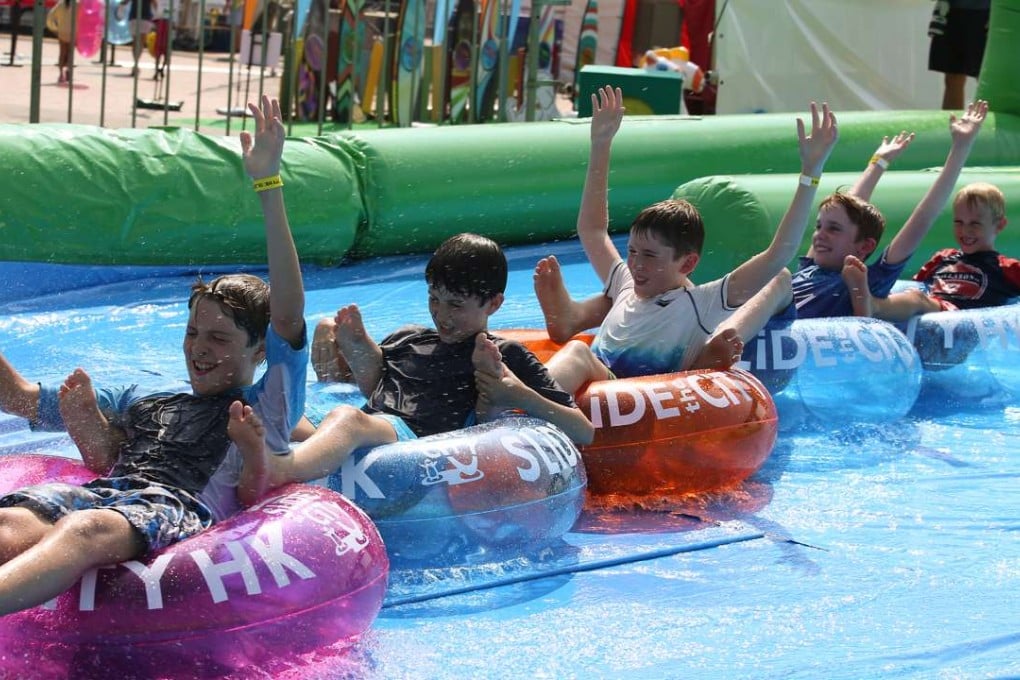 Youngsters beat the heat on the 10-metre slide. Photo: Nora Tam