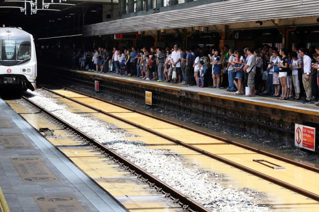 Passengers wait at the train station in Sheung Shui after the burst water pipe caused delays. Photo: K. Y. Cheng