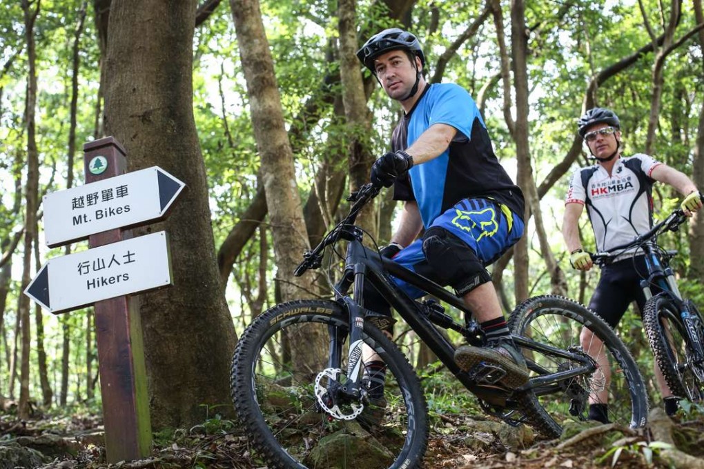 Mountain bikers Nick Dover (left) and Steve Coward ride a trail near Tai Mo Shan. Photo: Nora Tam