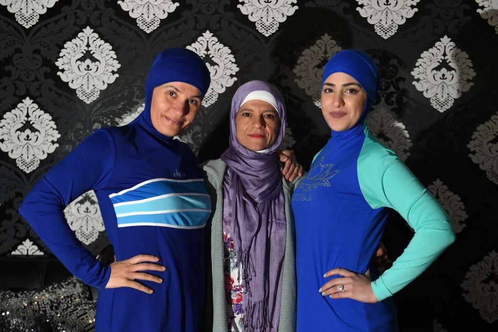 Models clad in burkini swimsuits pose with Australian-Lebanese designer Aheda Zanetti in western. Photo: AFP