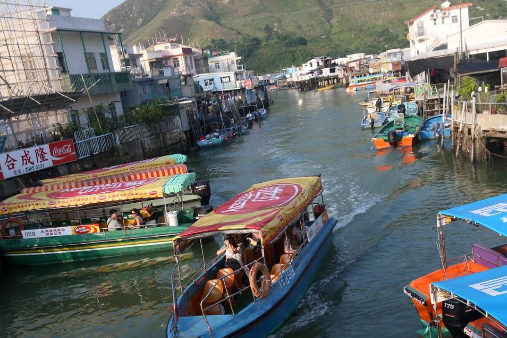 Tourists and locals hop on to a boat at the fishing village of Tai O. For HK$25 passengers are treated to a 20-minute ride in waters off northwestern Lantau. Photos: David Wong