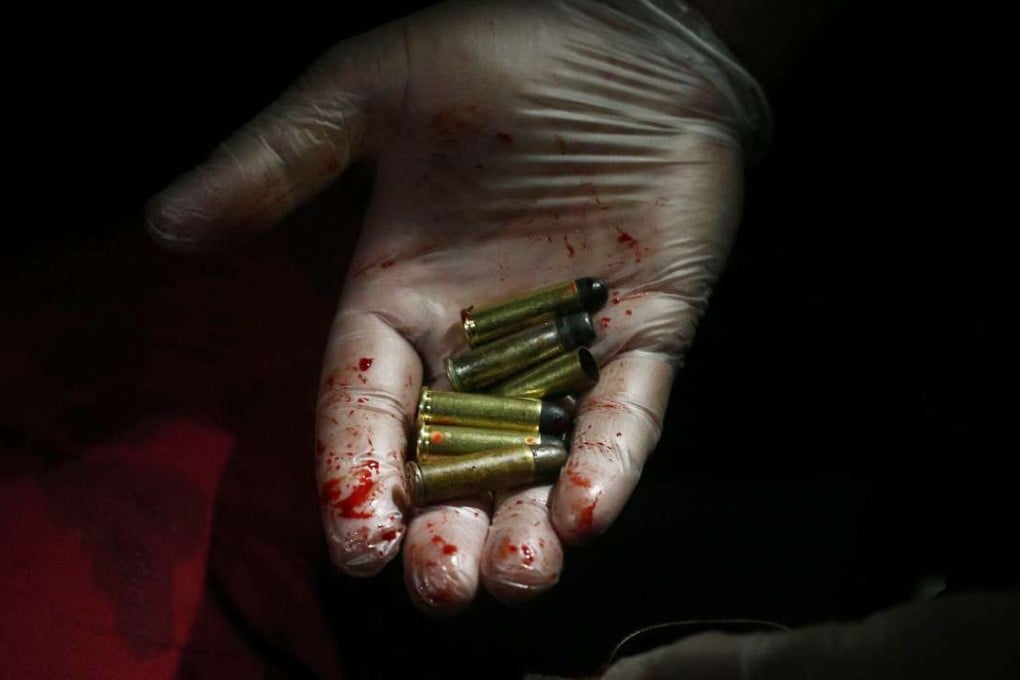 A police officer with recovered evidence after an operation against illegal drugs in Manila. Photo: EPA