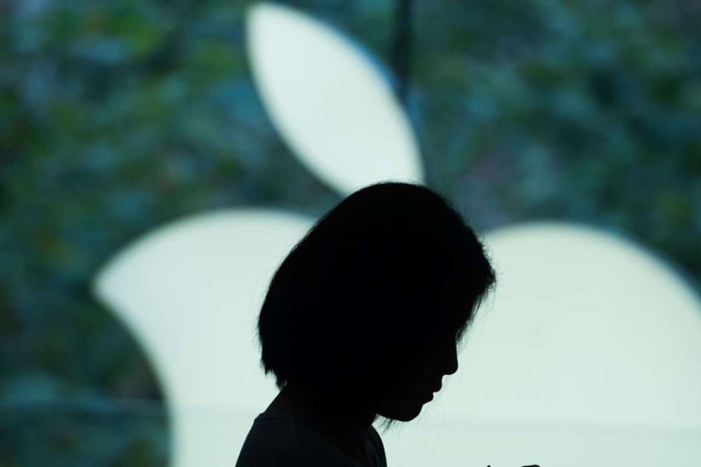 A customer uses her new smartphone during the release of the iPhone 6s at an Apple store in Shanghai. Photo: AFP
