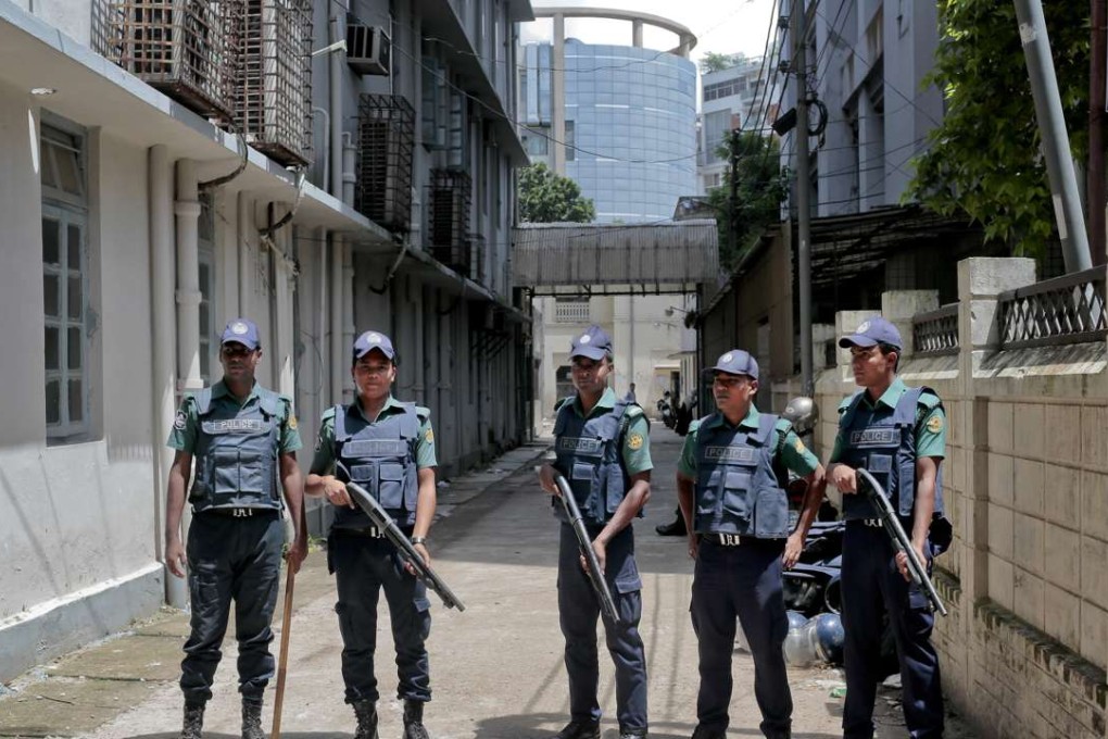 Bangladeshi policemen stand guard outside a morgue at the Dhaka Medical College Hospital during the autopsy on the bodies of suspected Islamic militants who were killed in Dhaka on Saturday. Photo: AP