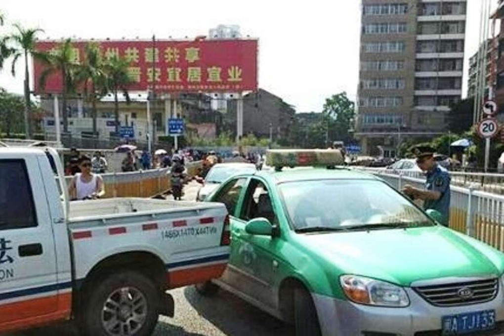 Chen's taxi is pulled up at road block at Fuzhou railway station, where he preyed on tourists unfamiliar with the area. Photo: SCMP Pictures