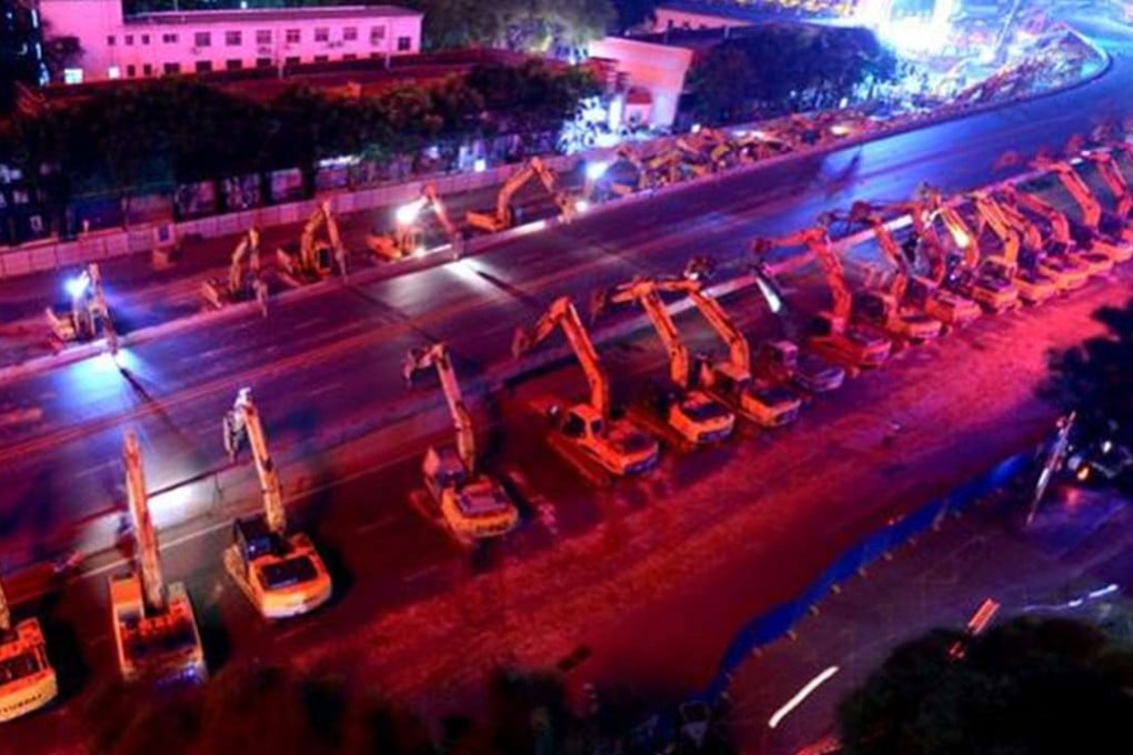 At about 10:30pm on Saturday, 86 excavators lined up either side of the overpass in Nanchang for the overnight demolition job. Photo: SCMP Pictures