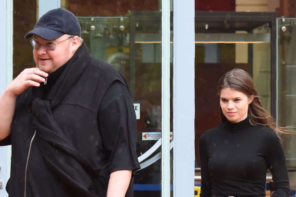 Internet mogul Kim Dotcom leaves with his girlfriend Elizabeth Donelly following his extradition appeal at the High Court in Auckland. Photo: AFP