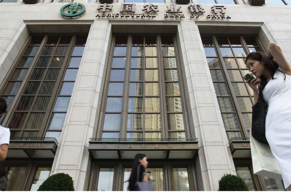 People walk pass Agricultural Bank of China Tower in Central, Hong Kong. Three of the country’s five largest banks have already reported first-half profit growth of between half a percentage point and 1.3 per cent, all weighed down by dwindling net interest income. Photo: Edward Wong