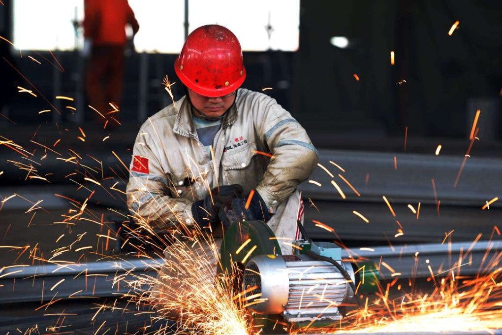 A worker polishes metal at steelworks factory in Rizhao, in eastern China's Shandong province. Photo: AFP