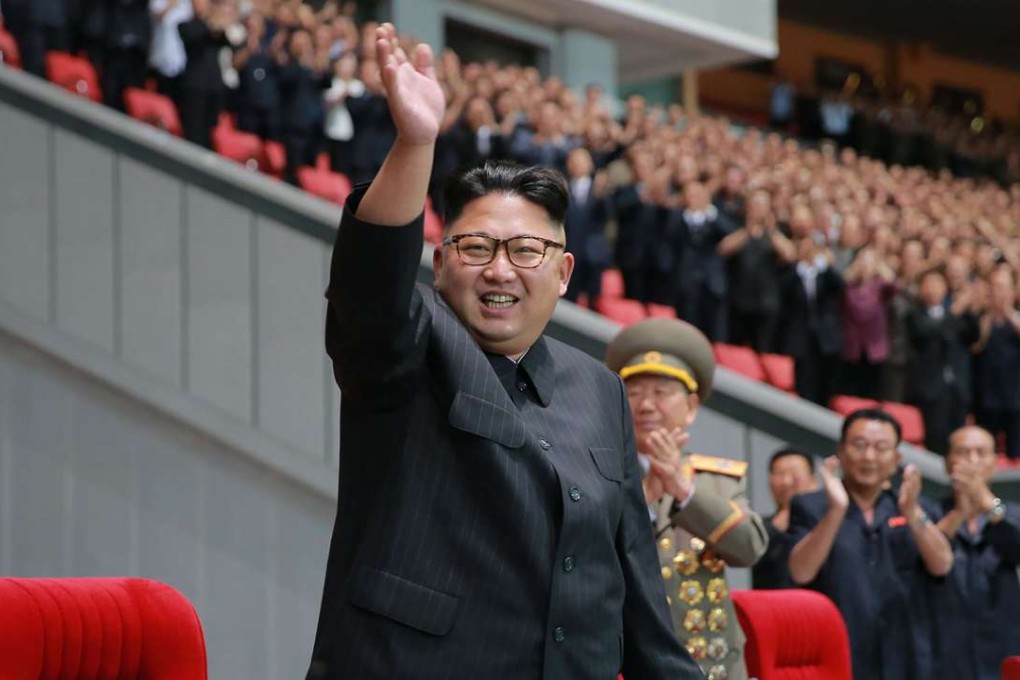 North Korean leader Kim Jong-Un waving while attending a torchlight gala of members of the youth vanguard. Photo: KCNA/AFP
