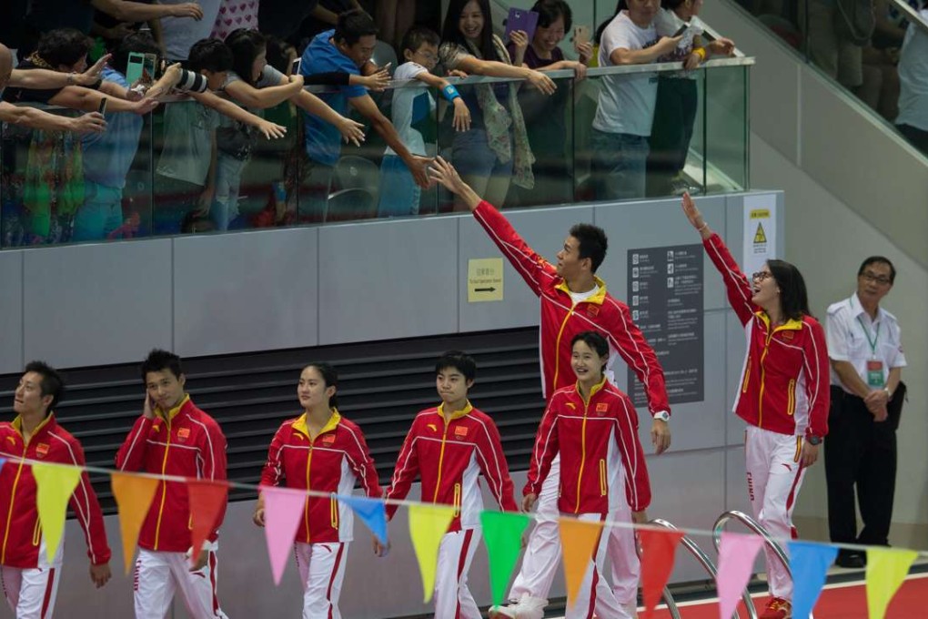 Hong Kong fans reach out to members of China’s Olympic team at Victoria Park swimming pool on August 28. The 45 athletes in the 64-member delegation on a three-day visit included the wildly popular bronze medallist swimmer, Fu Yuanhui. Photo: EPA