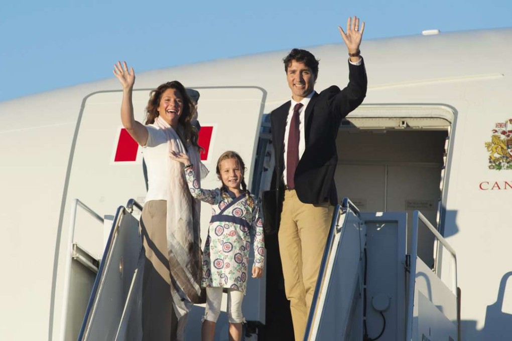 Canadian Prime Minister Justin Trudeau, his wife Sophie Gregoire and daughter Ella-Grace wave as they board a government plane in Ottawa, Ontario on Monday. Photo: AP