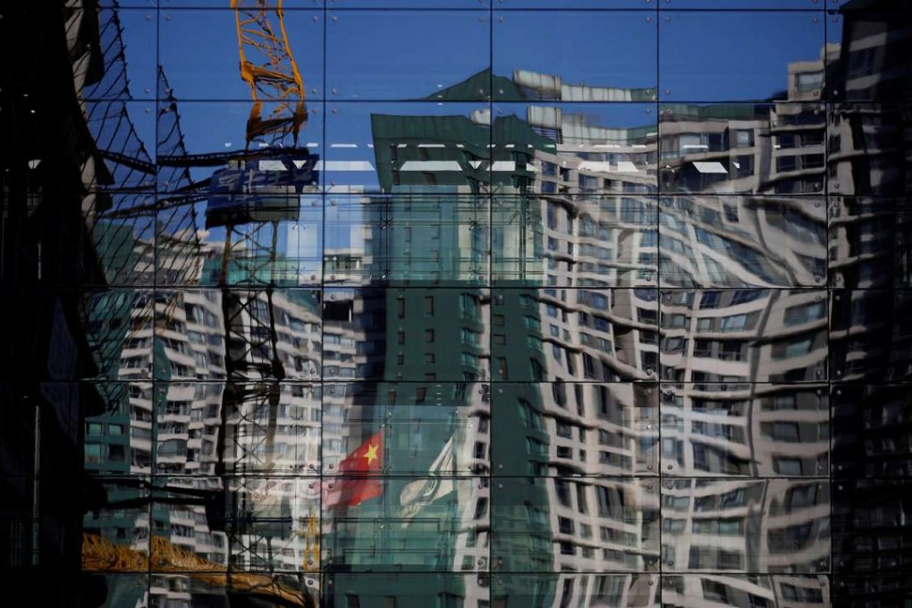A construction site and a residential building are reflected in the glass wall of a building in Beijing. To fully understand China, one must first understand the rest of the world. Photo: Reuters