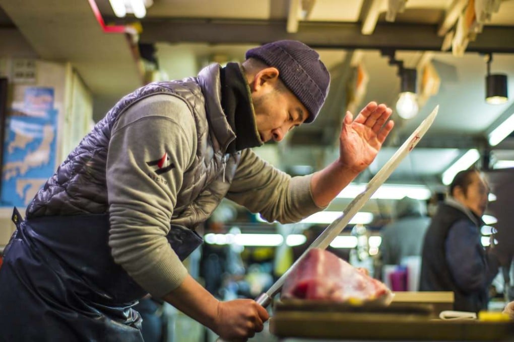 A worker slices tuna in a still from the documentary film Tsukiji Wonderland.