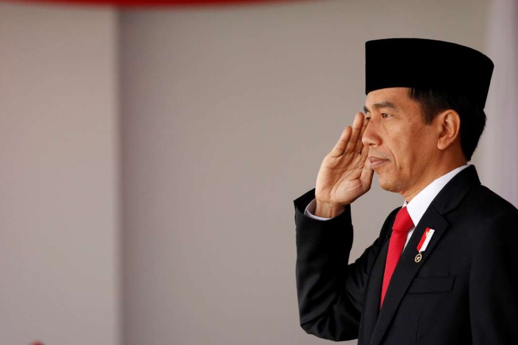 Indonesian President Joko Widodo salutes during celebrations for Indonesia's 71st Independence Day at the Presidential Palace in Jakarta. Photo: Reuters