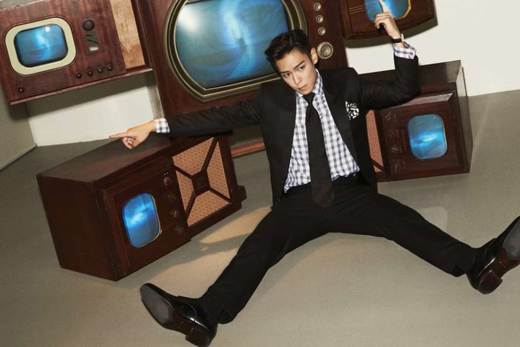 South Korean pop sensation T.O.P. poses with Nam June Paik’s Fat Boy (1997).