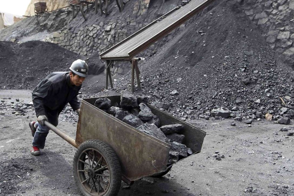 A worker pushes a cart at a coal mine owned by in Pinglu, Shanxi province. Photo: Reuters