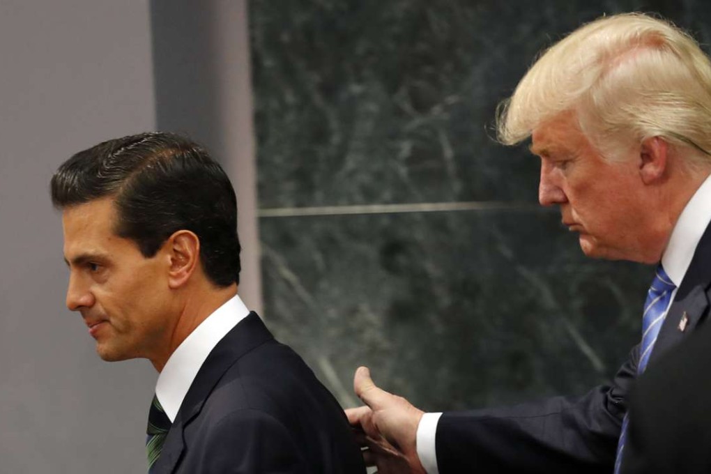 Republican presidential nominee Donald Trump walks with Mexico President Enrique Pena Nieto at the end of their joint statement at Los Pinos, the presidential official residence, in Mexico City, on Wednesday. Photo: AP