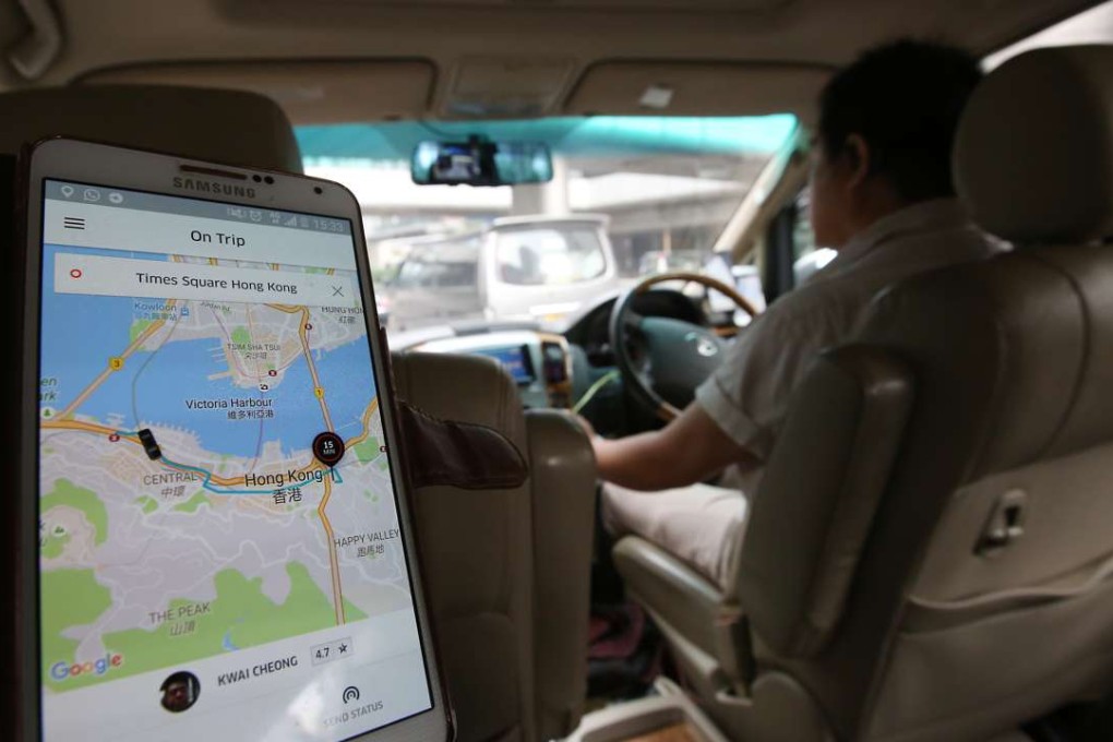 Customer uses the Uber apps in Wan Chai. Photo: Edward Wong