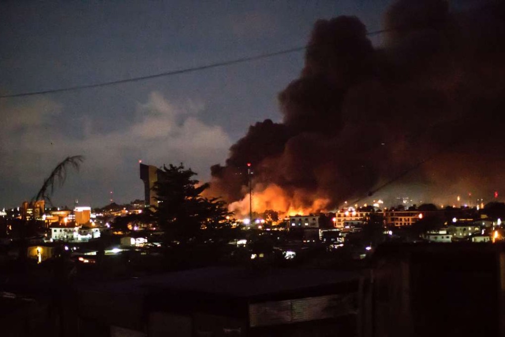 Smoke and flames are pictured billowing from the National Assembly building in Libreville after it was set ablaze on August 31 after Gabon's president Ali Bongo was declared winner of last weekend's contested election. Photo: AFP